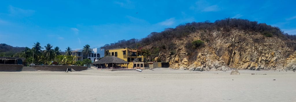 La Bocana Beach in Huatulco looking toward cliff side villas 