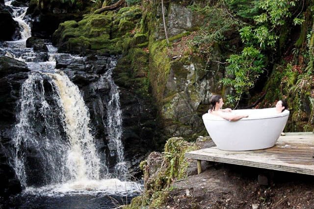 Eco retreat outdoor bathtub near a waterfall and gorge in scotland