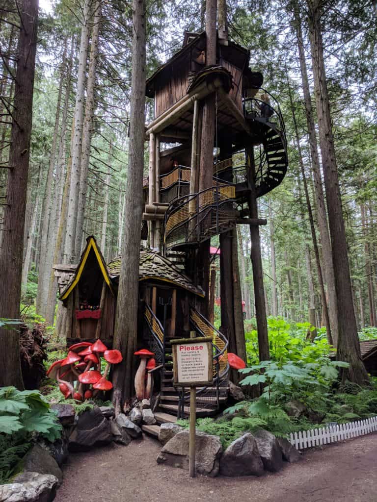 a whimsical treehouse in the middle of the forest