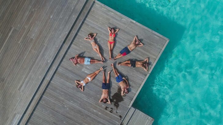 people laying on a dock in a circle