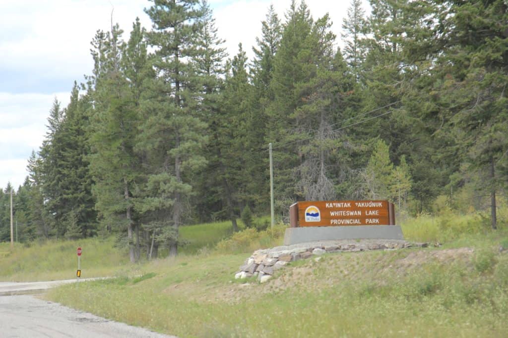 a brown park entrance sign off the highway