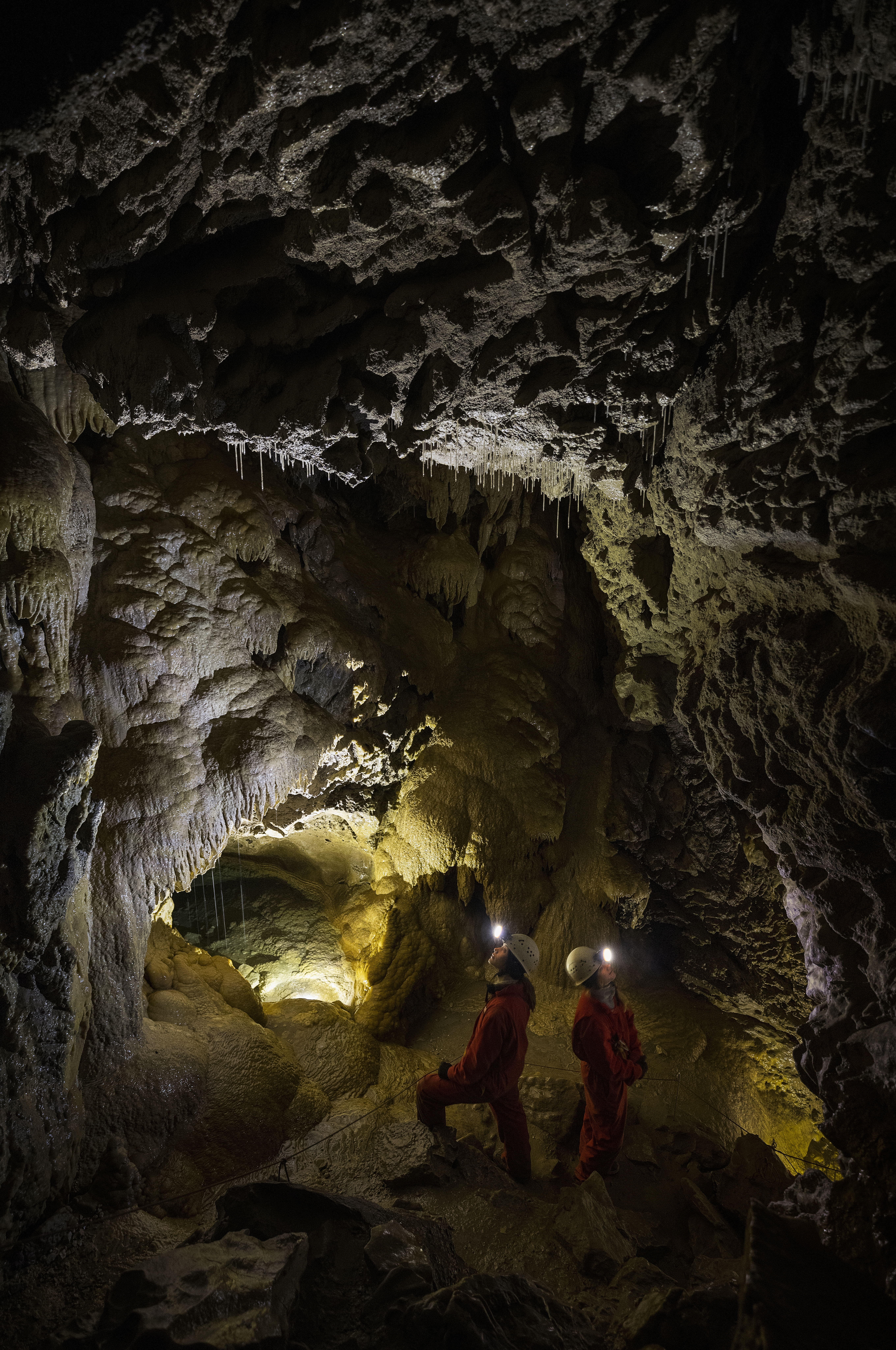 two people explore an underground cave