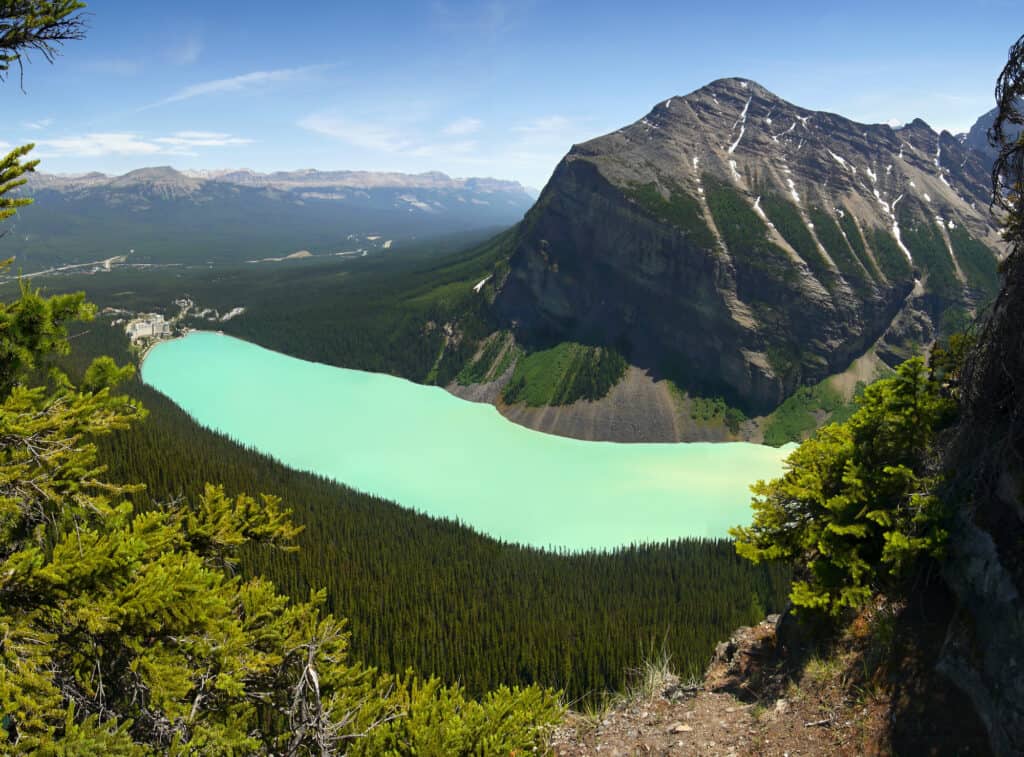 a view in the mountains above a mily-turquoise green lake