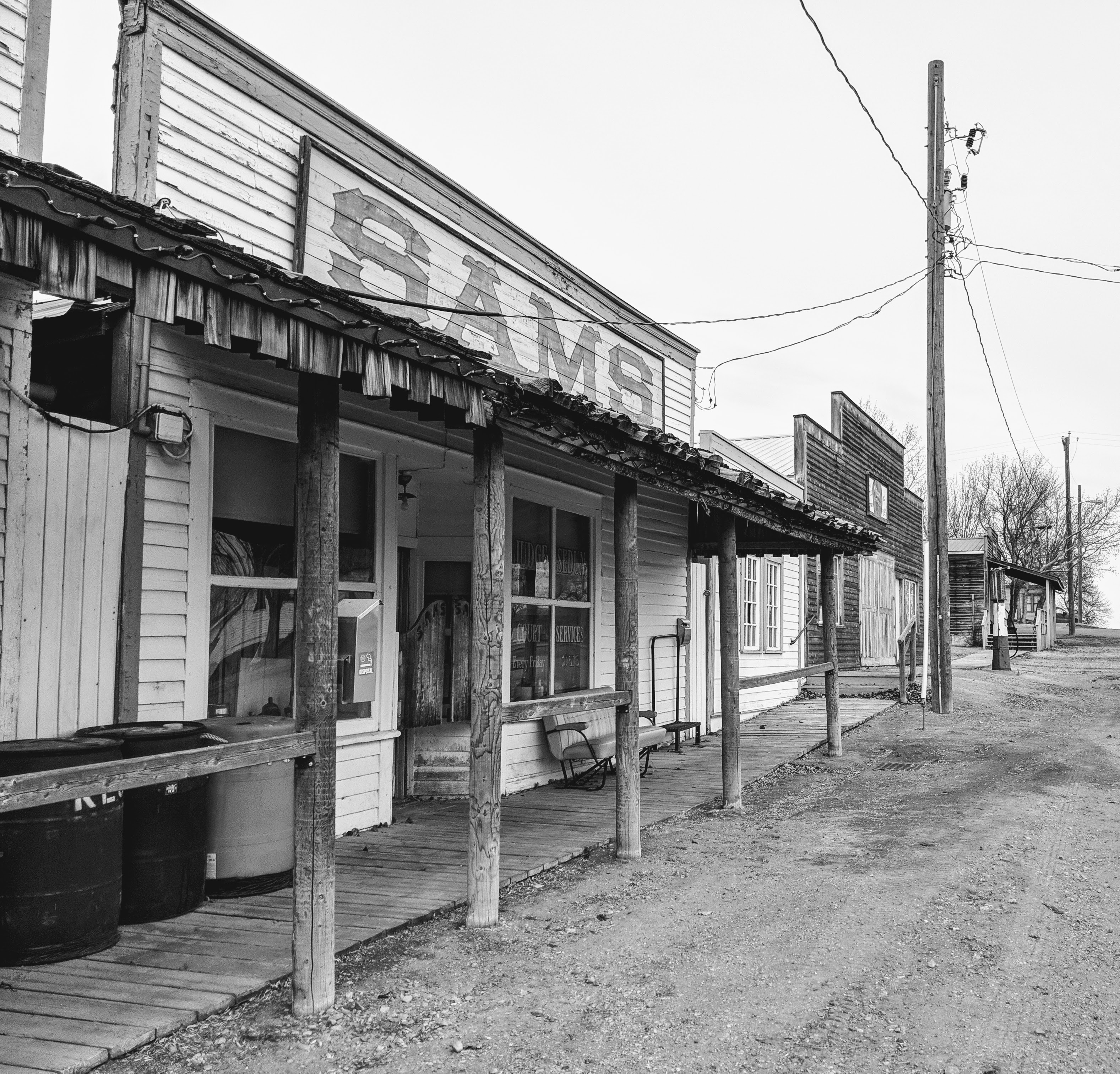 a main street in a ghost town with abandoned buildings